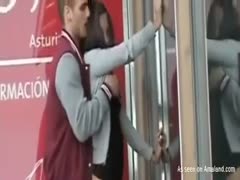 A young, shameless pair of bonks near a store on the street